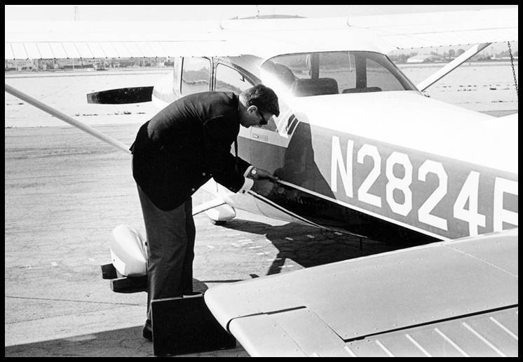 Opening the Two-Four
                    Fox's luggage compartment at Orange County Airport